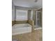 Bathroom featuring a garden tub and a tiled shower at 976 Buckhorn Bnd, Locust Grove, GA 30248