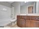 A full bathroom with a white tub and wooden cabinets at 976 Buckhorn Bnd, Locust Grove, GA 30248