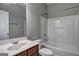 Bathroom with a white tub, toilet, and wooden cabinets at 976 Buckhorn Bnd, Locust Grove, GA 30248