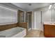 Bathroom featuring a soaking tub, a glass shower, and a wood vanity at 976 Buckhorn Bnd, Locust Grove, GA 30248