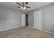 Bedroom with neutral carpet, a ceiling fan, and access to the bathroom at 976 Buckhorn Bnd, Locust Grove, GA 30248