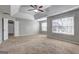 Bright bedroom with carpet, neutral paint, a ceiling fan and view of the yard at 976 Buckhorn Bnd, Locust Grove, GA 30248