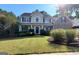 Charming two-story home featuring manicured lawn and inviting front porch at 976 Buckhorn Bnd, Locust Grove, GA 30248
