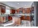 Well-appointed kitchen featuring wood cabinets, stainless appliances, and center island at 976 Buckhorn Bnd, Locust Grove, GA 30248
