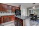 Spacious kitchen with island, dark wood cabinets, and stainless steel refrigerator at 976 Buckhorn Bnd, Locust Grove, GA 30248