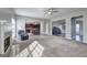 Open-concept living room with plush carpeting, fireplace, and seamless access to the kitchen at 976 Buckhorn Bnd, Locust Grove, GA 30248