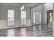 Bright living room featuring large windows and elegant wainscoting at 976 Buckhorn Bnd, Locust Grove, GA 30248