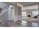 Cozy living room with fireplace adjacent to the stairway at 976 Buckhorn Bnd, Locust Grove, GA 30248