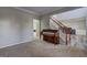Living room and staircase with carpet and a piano at 976 Buckhorn Bnd, Locust Grove, GA 30248