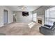 Bright living room featuring plush carpeting, fireplace and ceiling fan at 976 Buckhorn Bnd, Locust Grove, GA 30248