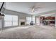 Sun-filled living room with plush carpeting, fireplace, and direct access to the eat-in kitchen at 976 Buckhorn Bnd, Locust Grove, GA 30248