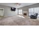 Spacious living room with plush carpeting, fireplace, and abundant natural light at 976 Buckhorn Bnd, Locust Grove, GA 30248