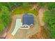 A new construction home surrounded by trees, with a long driveway at 115 Oak Road, Locust Grove, GA 30248