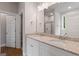 Bathroom featuring a double vanity with granite countertops and a large mirror reflecting the space at 115 Oak Road, Locust Grove, GA 30248