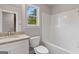 Bright bathroom with a white vanity, granite countertop, and a tub with white ceramic tile at 115 Oak Road, Locust Grove, GA 30248
