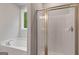 Contemporary bathroom featuring a shower with glass doors and a luxurious soaking tub at 115 Oak Road, Locust Grove, GA 30248