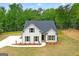 Charming new construction home with white siding, black shutters, and a well-manicured lawn at 115 Oak Road, Locust Grove, GA 30248
