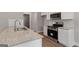 Bright kitchen with stainless steel appliances, granite countertops, and white subway tile backsplash at 115 Oak Road, Locust Grove, GA 30248