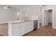 Kitchen island with stainless steel dishwasher, granite countertops, and white cabinets at 115 Oak Road, Locust Grove, GA 30248
