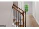A staircase features dark wood railings and white painted risers, leading to the second floor at 115 Oak Road, Locust Grove, GA 30248