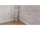 Utility room with a new hot water tank, washer, and dryer hookups, and laminate flooring at 115 Oak Road, Locust Grove, GA 30248