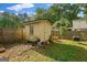 Backyard storage shed with a grill situated on a well maintained lawn and a partial fence line at 235 Castlegate Cir, Carrollton, GA 30116