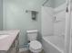Bright bathroom with a shower/tub combo featuring modern fixtures and neutral wall paint at 235 Castlegate Cir, Carrollton, GA 30116