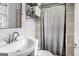 Well-lit bathroom featuring modern fixtures, neutral tile, and a shower with a curtain at 235 Castlegate Cir, Carrollton, GA 30116