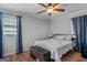Comfortable bedroom with a ceiling fan, a bench at the foot of the bed, and natural light at 235 Castlegate Cir, Carrollton, GA 30116
