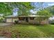 Charming brick home with a well-manicured front yard, mature trees, and a two-car garage at 235 Castlegate Cir, Carrollton, GA 30116