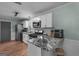 Bright kitchen featuring stainless steel appliances, granite countertops, white cabinets and bar seating at 235 Castlegate Cir, Carrollton, GA 30116
