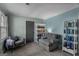 Comfortable sitting room features arm chairs, side tables and built in bookshelves at 235 Castlegate Cir, Carrollton, GA 30116