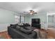 Bright living room with large sectional, TV, and access to an outdoor living space at 235 Castlegate Cir, Carrollton, GA 30116