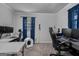 Office space with dual monitors, blue curtains and a sleek, black office chair at 235 Castlegate Cir, Carrollton, GA 30116