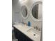 Modern bathroom boasts dual sinks, white framed mirrors, and a dark vanity at 1962 Markone Nw St, Atlanta, GA 30318