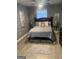 Cozy bedroom featuring a ceiling fan, queen sized bed, wall art, and neutral decor at 1962 Markone Nw St, Atlanta, GA 30318