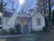 Charming home featuring a yellow door, covered entryway, and a landscaped front yard at 1962 Markone Nw St, Atlanta, GA 30318