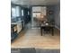 Modern kitchen and dining area with stainless steel appliances, white cabinets, and luxury vinyl floors at 1962 Markone Nw St, Atlanta, GA 30318