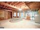 Spacious unfinished basement area with a fireplace, windows, and exposed wood framing at 260 Emerald Lake Dr, Fayetteville, GA 30215