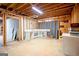 Unfinished basement with exposed beams, concrete floor, and a utility sink at 260 Emerald Lake Dr, Fayetteville, GA 30215