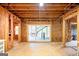 Unfinished basement area with exposed wood framing, sliding glass doors, and access to the backyard at 260 Emerald Lake Dr, Fayetteville, GA 30215