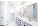 Bathroom featuring a double sink vanity with large mirrors and access to another room at 260 Emerald Lake Dr, Fayetteville, GA 30215