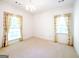 Spacious bedroom with neutral carpet, white walls, two windows, and crown molding at 260 Emerald Lake Dr, Fayetteville, GA 30215