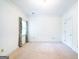 Bright bedroom with neutral carpet, white walls, and classic window trim at 260 Emerald Lake Dr, Fayetteville, GA 30215
