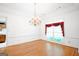 Bright dining room with hardwood floors, a chandelier, and large window at 260 Emerald Lake Dr, Fayetteville, GA 30215