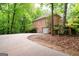 Brick home exterior with a long driveway, mature trees, and a two-car garage at 260 Emerald Lake Dr, Fayetteville, GA 30215