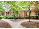 Charming brick home featuring a well-maintained lawn and mature trees at 260 Emerald Lake Dr, Fayetteville, GA 30215