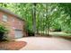 Brick home exterior with a long driveway, mature trees, and a two-car garage at 260 Emerald Lake Dr, Fayetteville, GA 30215