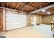 Unfinished garage with a white garage door, utility sink, and exposed framing and insulation at 260 Emerald Lake Dr, Fayetteville, GA 30215