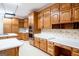 A kitchen featuring custom oak cabinets, stainless steel appliances, and ample counter space at 260 Emerald Lake Dr, Fayetteville, GA 30215